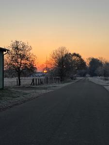 an empty road with the sunset in the background at Das Haus am Teich in Besitz