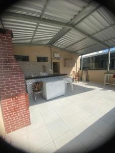 een groot buitenterras met een tafel en een open haard bij Dormitório Barreto in Bom Jesus da Lapa