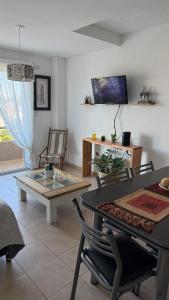 a living room with a glass table and chairs at Departamento Boulevares in Concepción del Uruguay +10 photos