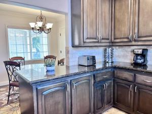 a kitchen with wooden cabinets and a counter top at Destination #12 in Anaheim