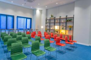 a room with green and red chairs in a room at ORBI CITY- Luxury Panorama Sea View in Batumi