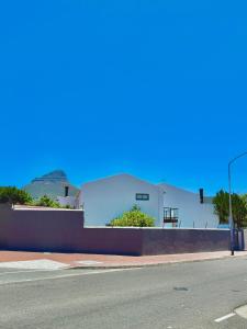 a white building on the side of a street at The White House - Zonnebloem in Cape Town