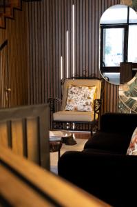 a living room with a chair and a couch at Je T'aime Solar São João in São João da Madeira