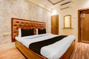 a bedroom with a large bed in a room at Hotel O Gangay in Prayagraj