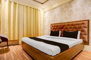 a bedroom with a large bed in a room at Hotel O Gangay in Prayagraj