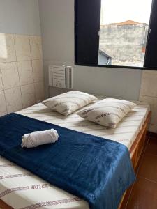 two beds in a room with a towel on them at Hotel anoitecer - Rodoviária Tietê, Anhembi, Expo Center in Sao Paulo +23 photos