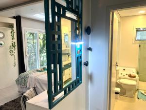 a door to a bathroom with a toilet and a bedroom at Rosa Casa Morar da Serra in Canela +52 photos