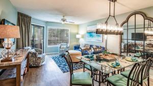 a dining room and living room with a dining table and chairs at Kingston Plantation - Laurel Court #112 - Seaclusion in Myrtle Beach