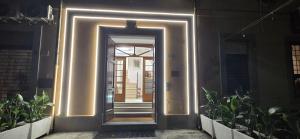 a hallway with a door with lights on it at Albergo Flaminia Rooms Grottarossa in Rome