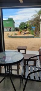 a patio with a table and chairs and a building at Kennedy's Hotel in Itatiba