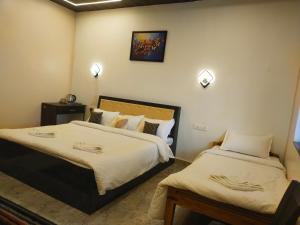 Ένα ή περισσότερα κρεβάτια σε δωμάτιο στο Tiger Home Stay Resort