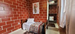 a small room with a bed in a brick wall at Pousada Itatiba Holliday in Itatiba +123 photos