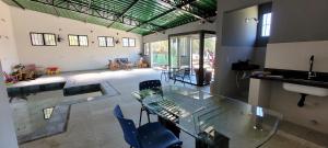 a large room with a glass table and chairs at Pousada Itatiba Holliday in Itatiba