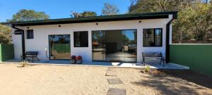 a house with a green and white at Pousada Itatiba Holliday in Itatiba