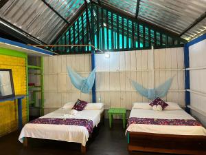 Ένα ή περισσότερα κρεβάτια σε δωμάτιο στο Cabañas Arrecifes