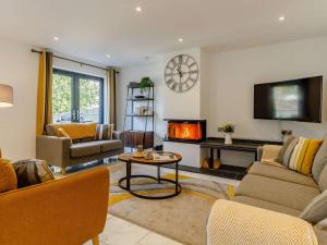 un salon avec un canapé et une cheminée dans l'établissement 4 Bed in Bude 89355, à Poughill