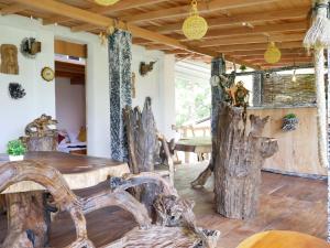 a room with a table and some logs at Wood Aura Ella in Ella