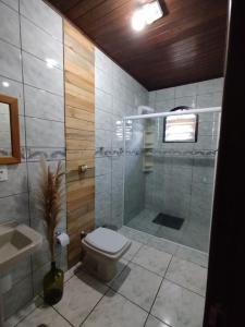 a bathroom with a shower and a toilet and a sink at Mini House Park in Campo Alegre +53 photos