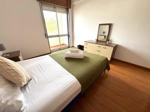 a bedroom with a bed with a mirror and a dresser at Faro Family Apartment in Faro