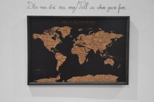 a map of the world in a frame on a wall at La Maison des Trois in Beausoleil