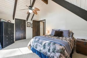 a bedroom with a bed and a ceiling fan at Boss's Cabin - Boss-level views, zero stress! in Shaver Lake
