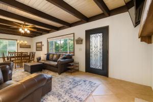 a living room with a couch and a door at Boss's Cabin - Boss-level views, zero stress! in Shaver Lake