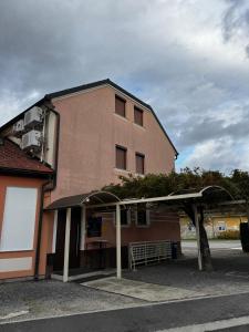 a large building with a shelter in front of it at Baroko Rooms & Apartments in Varaždin