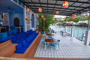 un restaurant avec des chaises et des tables bleues et l'eau dans l'établissement Watercolours, à Ko Chang