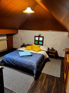 a bedroom with a large bed with yellow pillows at Baroko Rooms & Apartments in Varaždin