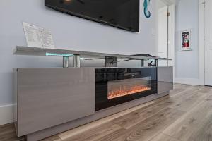 a fireplace in a living room with a tv above it at Salty waves 2 in Flagler Beach