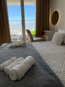 a hotel room with two towels on a bed at A2I - 33rd Floor SkyCity Residence With Skopje View in Skopje +9 photos
