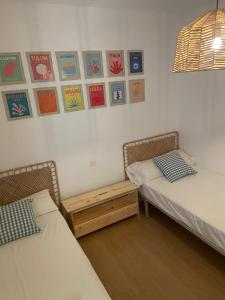 two beds and a table in a room at Palomera, Calafat, piscina, frente al mar, a 5 mn de la playa, wifi, zona residencial in Calafat +34 photos