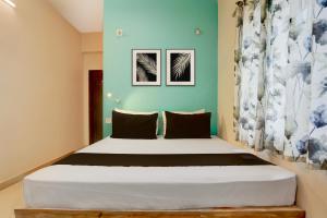 Ένα ή περισσότερα κρεβάτια σε δωμάτιο στο Townhouse Oak Tirupati Formerly Sky Towers