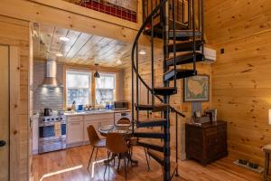 a kitchen with a spiral staircase in a log cabin at Retreat at Riverbend in West Jefferson +22 photos