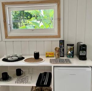 a kitchen with a counter with a window on it at Piesang Valley Cottage Djungle in Plettenberg Bay