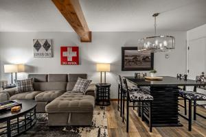 a living room with a couch and a table at Hot tubs and pool -Looping shuttle- Cozy fireplace in Steamboat Springs