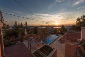 a view of a swimming pool from a house at Villa Sunset in Jadranovo