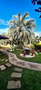 a park with a picnic table and a palm tree at Mini House Park in Campo Alegre
