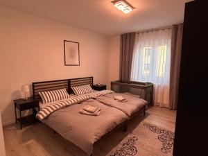 a bedroom with a bed with two towels on it at Ferienwohnung Daviana in Beckingen