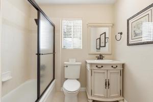 a bathroom with a toilet and a sink and a shower at Boss's Cabin - Boss-level views, zero stress! in Shaver Lake +52 photos