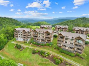 an aerial view of an apartment complex with mountains in the background at Endless Grandfather View at Echota in Valle Crucis
