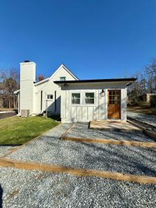a white house with a driveway in front of it at Lake House get away in Whitsett