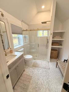 a bathroom with a shower and a toilet and a sink at Lake House get away in Whitsett