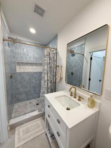 a white bathroom with a sink and a shower at Lake House get away in Whitsett