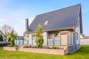 a white house with a black roof at Ferienhaus Poolaris in Pruchten