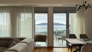 a living room with a couch and a table at Seaview Apartment in Bečići