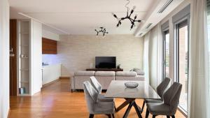 a living room with a table and a couch at Seaview Apartment in Bečići