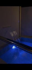 a glass table with blue light on top of it at Thuraya chalet in Nizwa