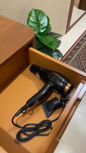 a black hairdryer is sitting in a box at Thuraya chalet in Nizwa