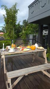 a picnic table with food on it on a deck at The Next Door in Kandy